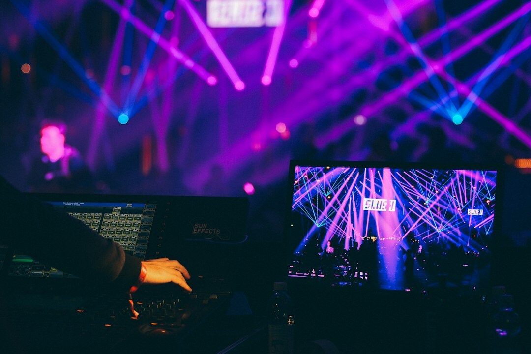 Streaming operator managing a live broadcast from a laptop and monitors